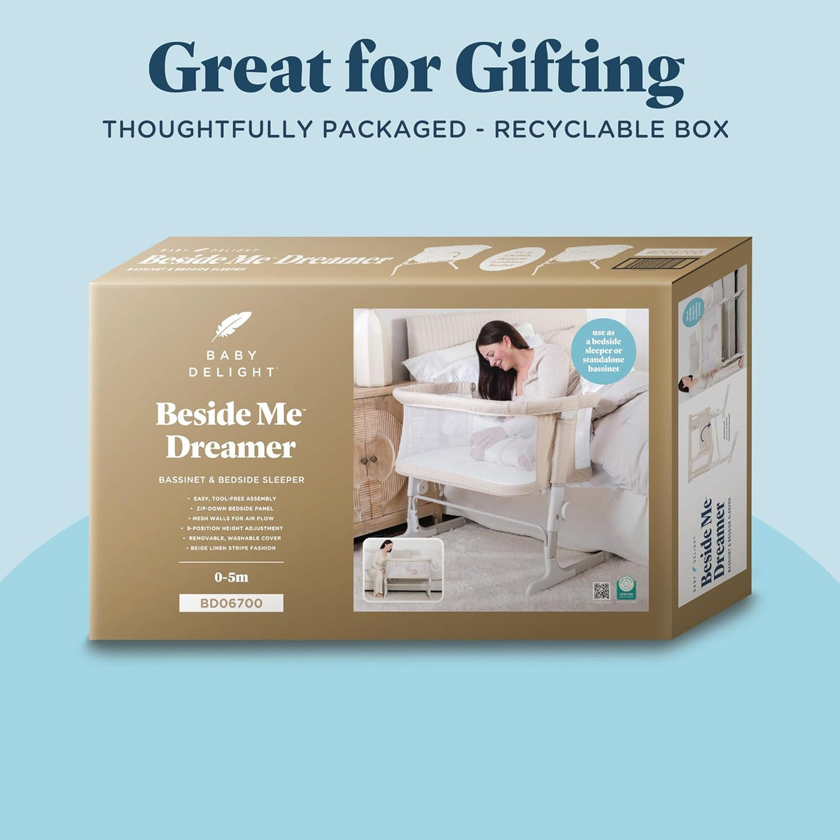 Rectangular product box showing the beige bassinet pictured on the front and branding on the packaging.