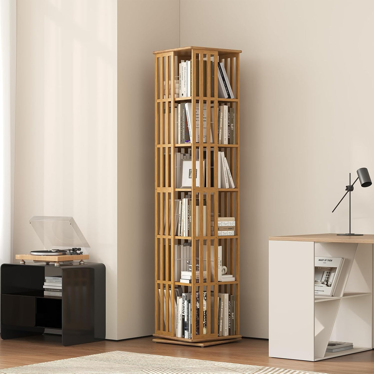 Tall bamboo rotating bookcase placed in a corner, filled with books and decor items.