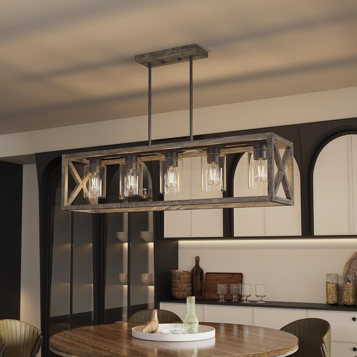 Long rectangular farmhouse chandelier with five glass-shaded bulbs hung above a dining table in a warm kitchen.