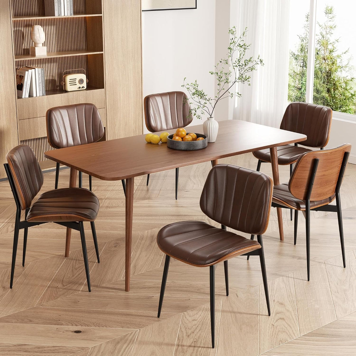 Dining table set in a bright room with five brown faux-leather chairs and walnut bentwood backs.