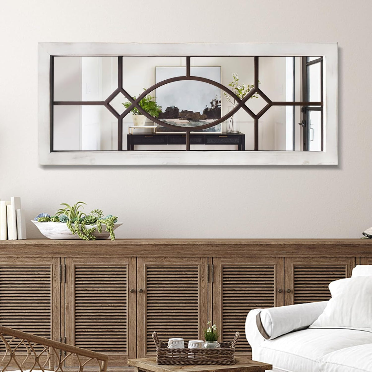 Windowpane mirror with brown interior slats hung horizontally above a wooden console in a neutral living area