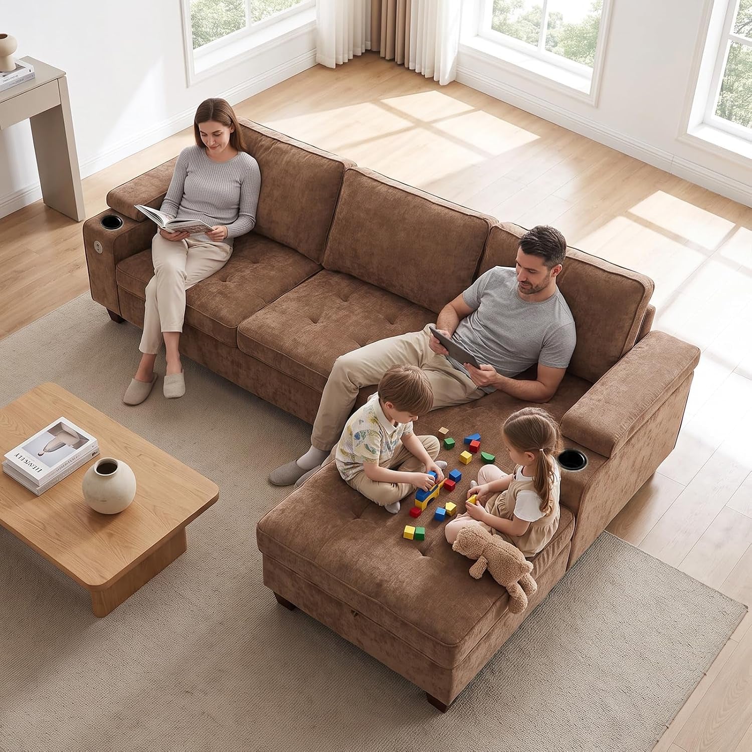 Top-down view of a brown chaise sectional with parents and two children playing with blocks on the ottoman