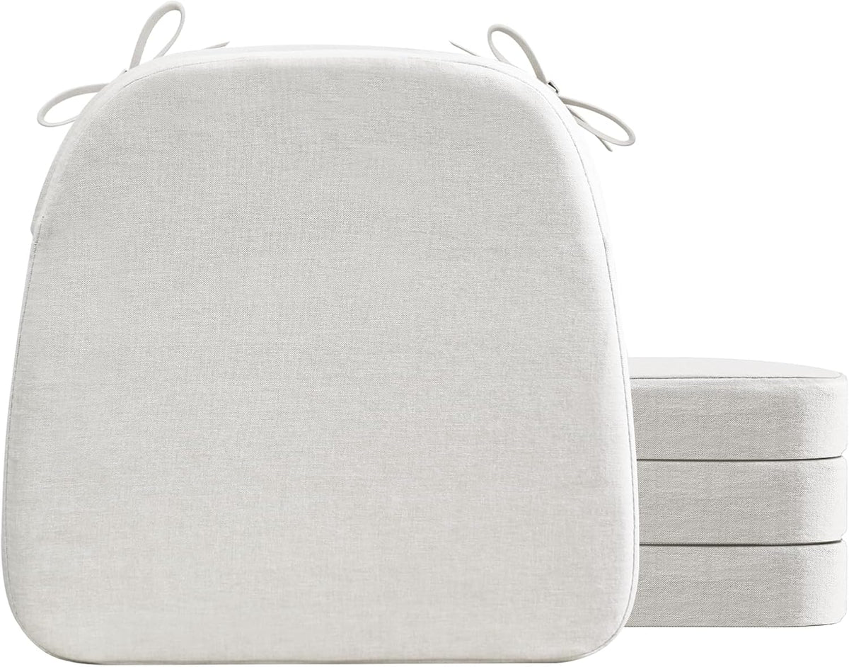 Front studio shot of a light cream D-shaped cushion upright with three matching cushions stacked behind, top ties visible.