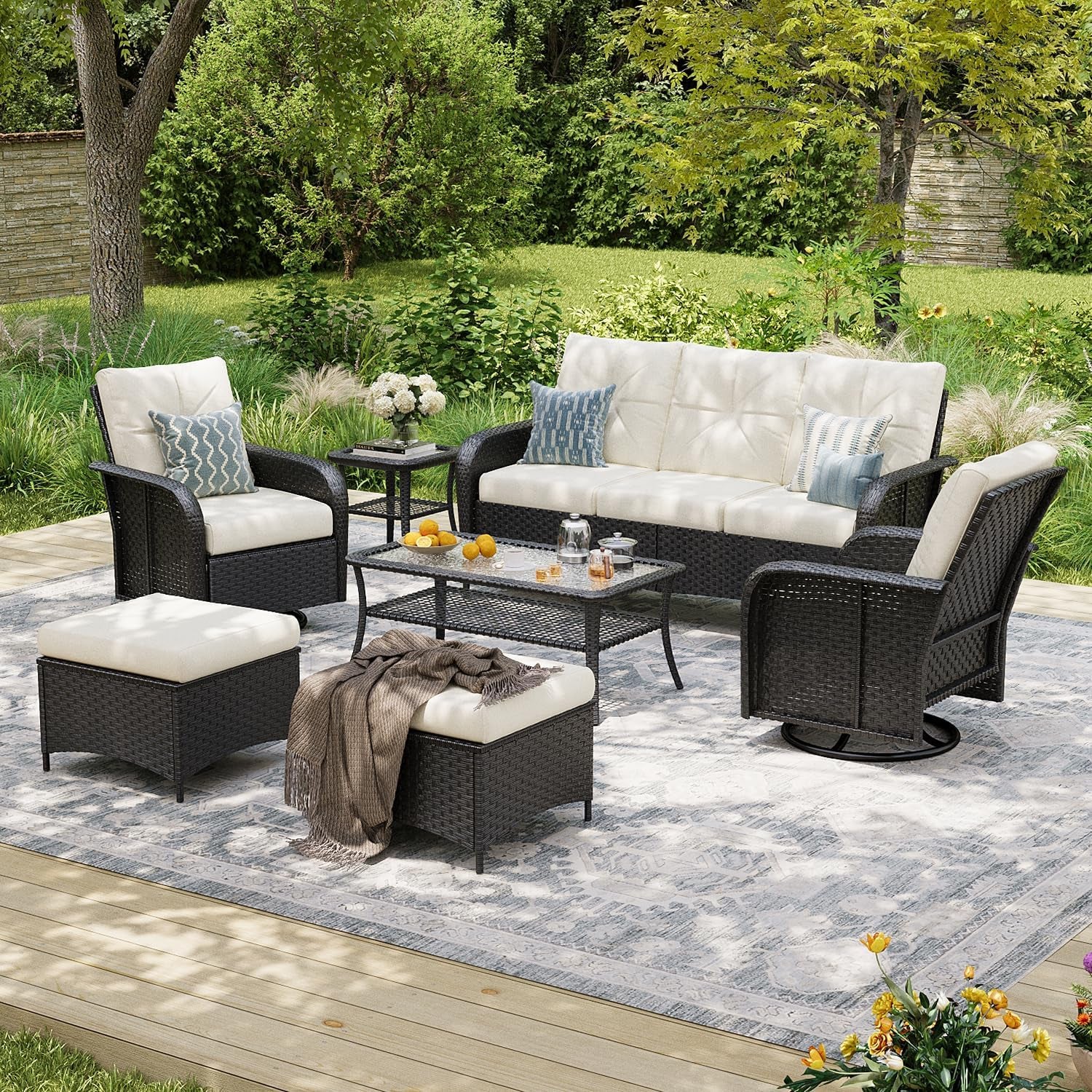 Dark wicker variant of the patio set with cream cushions, sofa, chairs, coffee table and two ottomans.