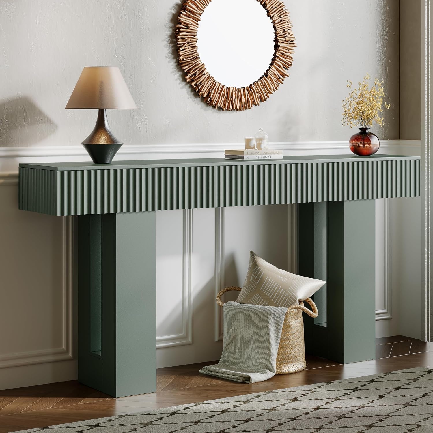Sage green fluted console table styled with a lamp and amber vase, basket of textiles tucked underneath