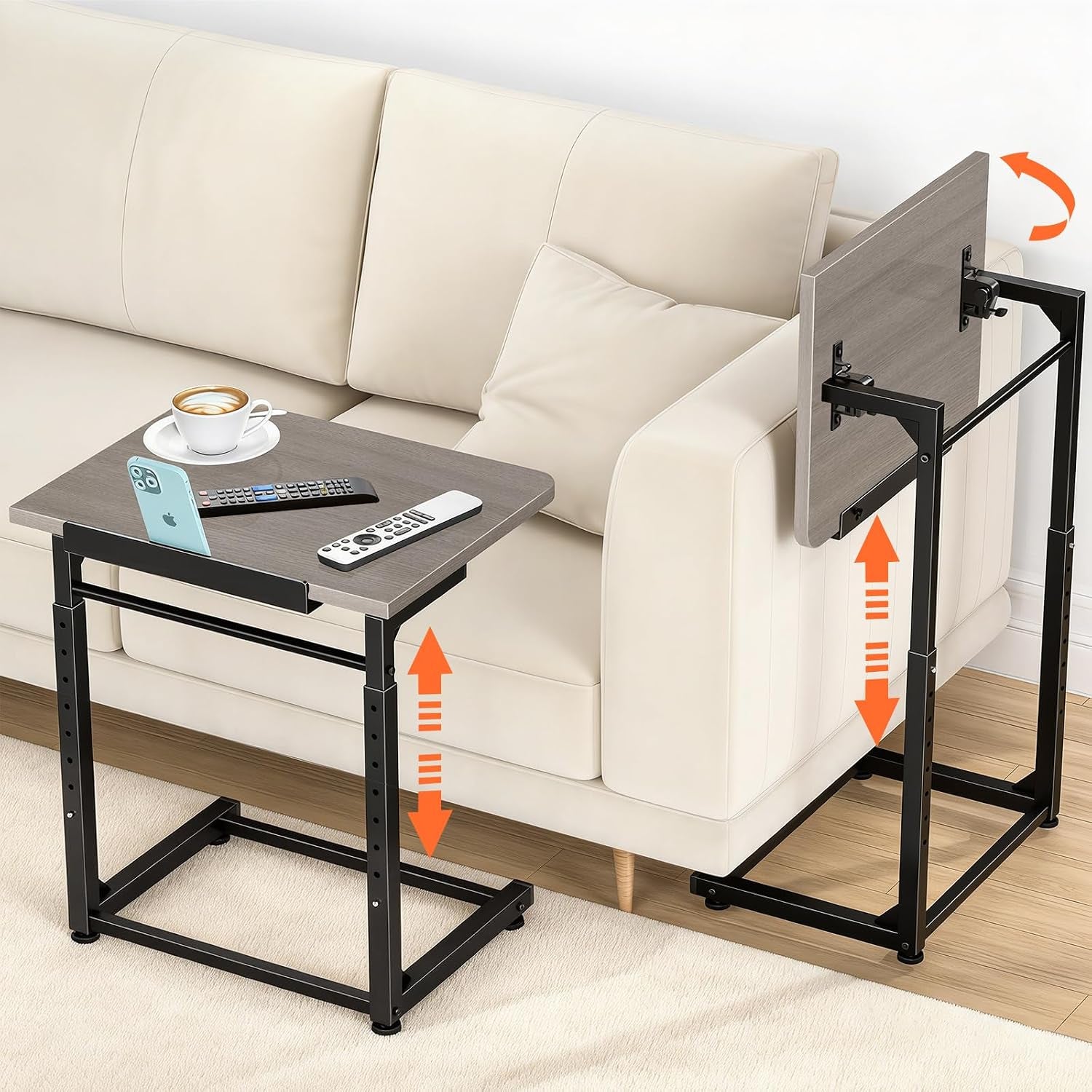 Gray wood-top C-shaped side table beside a cream sofa with cup, remotes and phone holder on top.