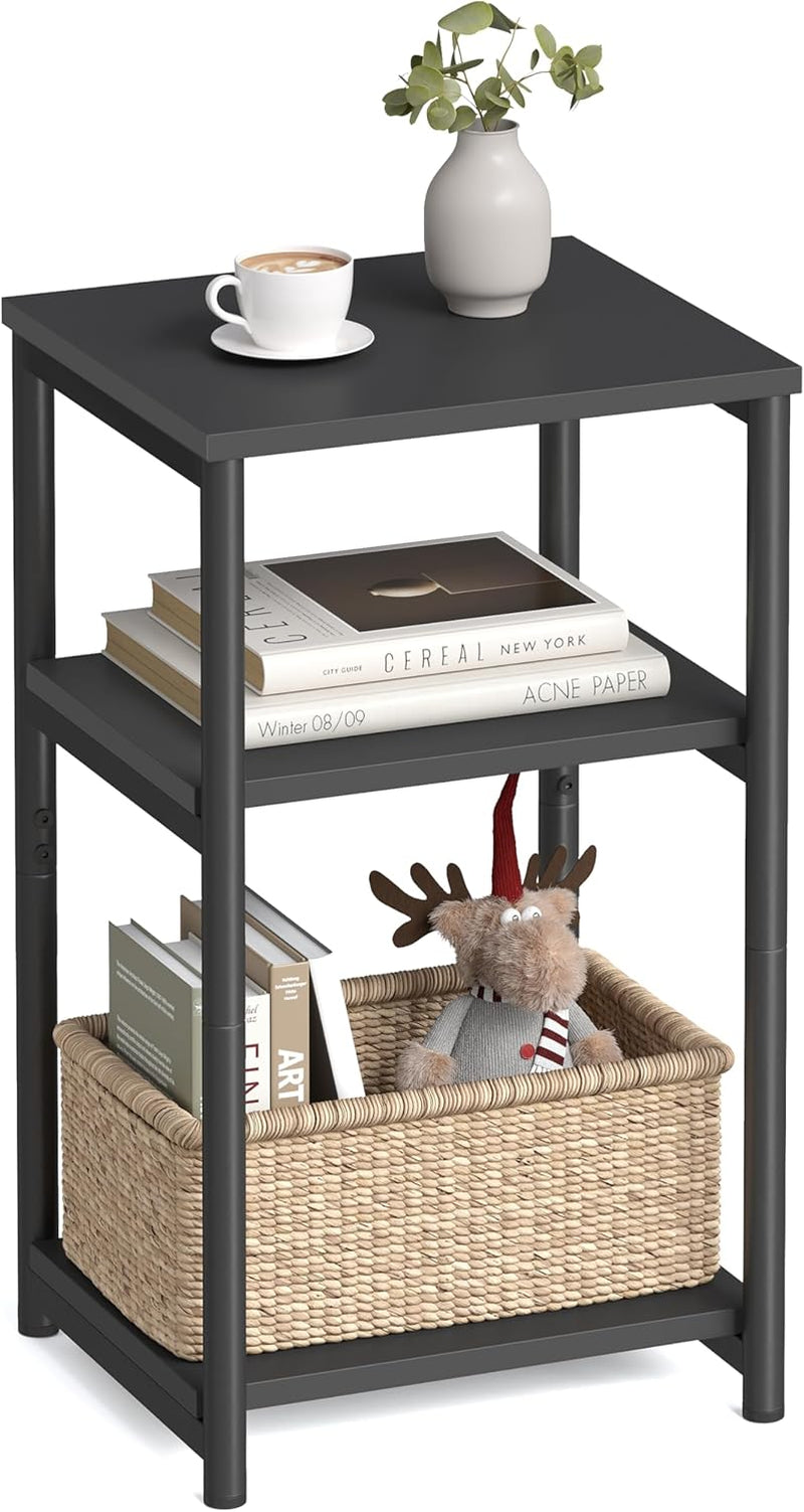 Three-tier black end table with books, a vase and a woven basket on the bottom shelf.