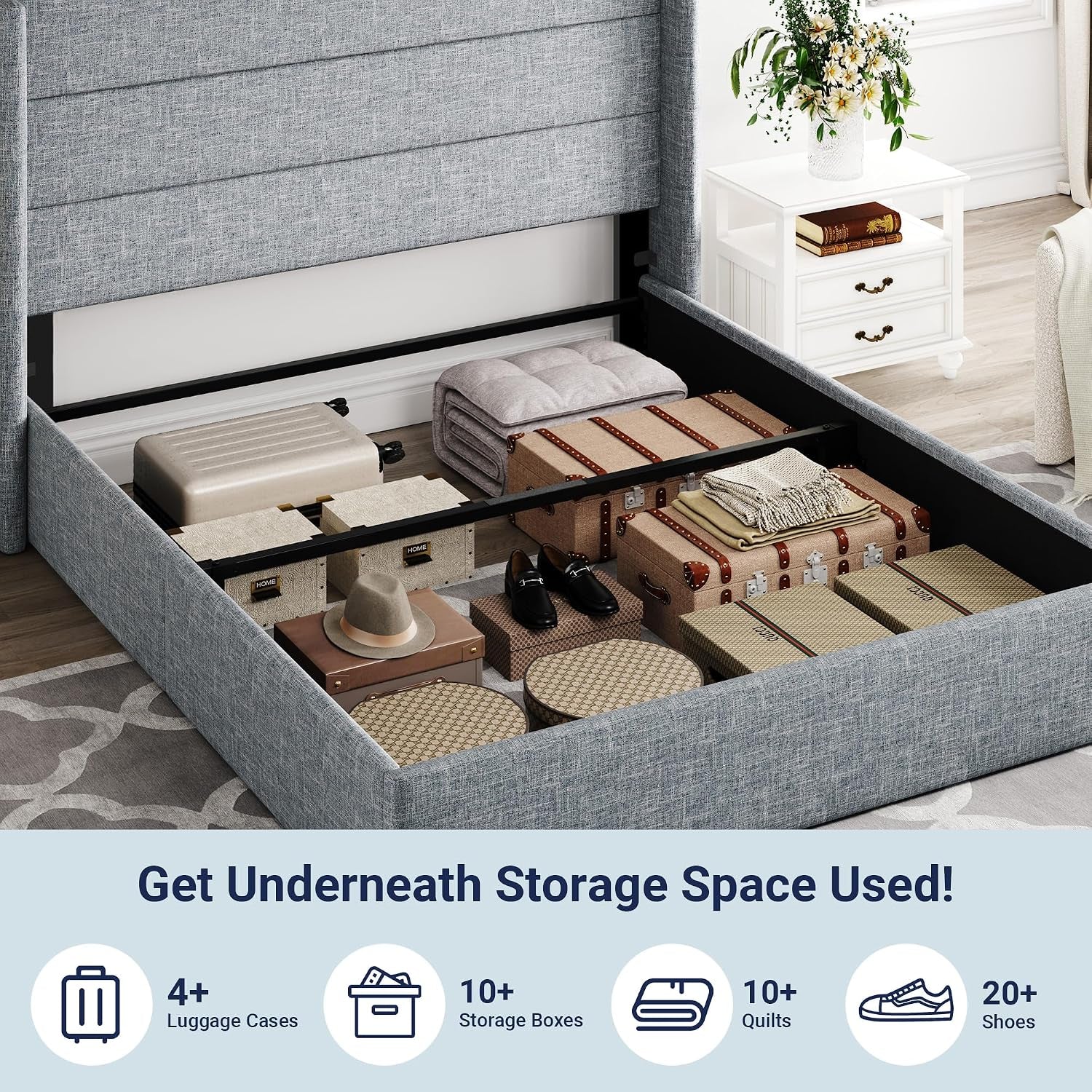 Top-down view of the bed with the mattress lifted showing organized storage with suitcases and boxes inside a gray