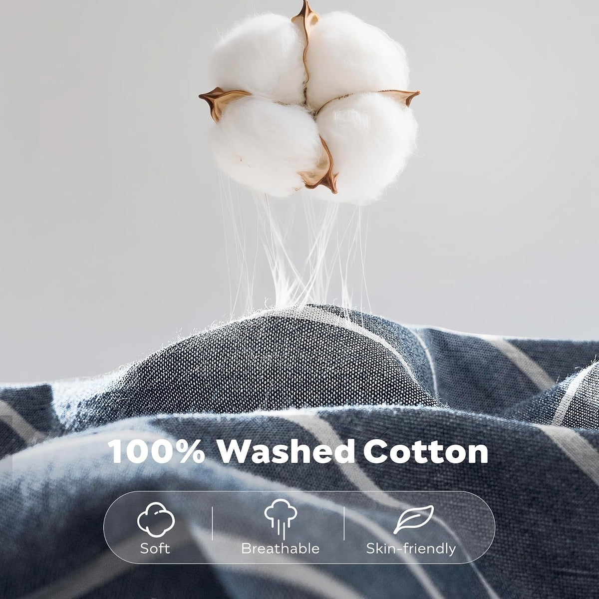 Close-up of a cotton boll hovering above soft blue striped fabric to illustrate material