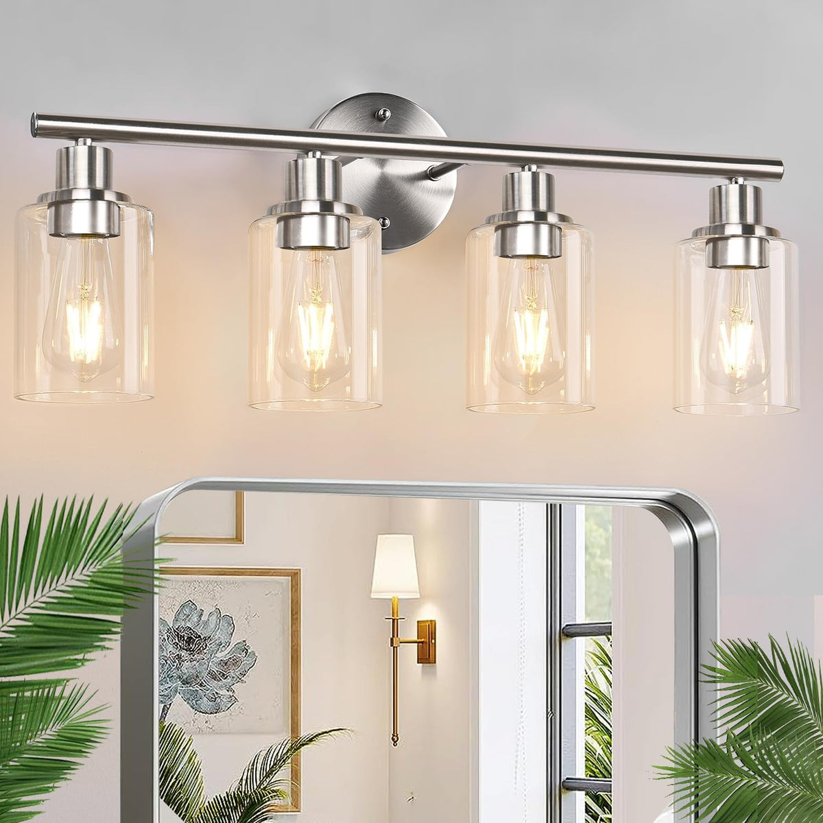 Four-light brushed nickel vanity light with four clear cylindrical glass shades and lit bulbs.
