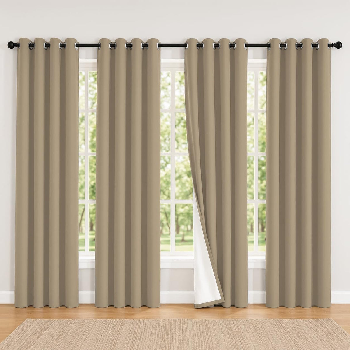 Wide window dressed with four light beige grommet panels, one slightly opened to reveal white backing.