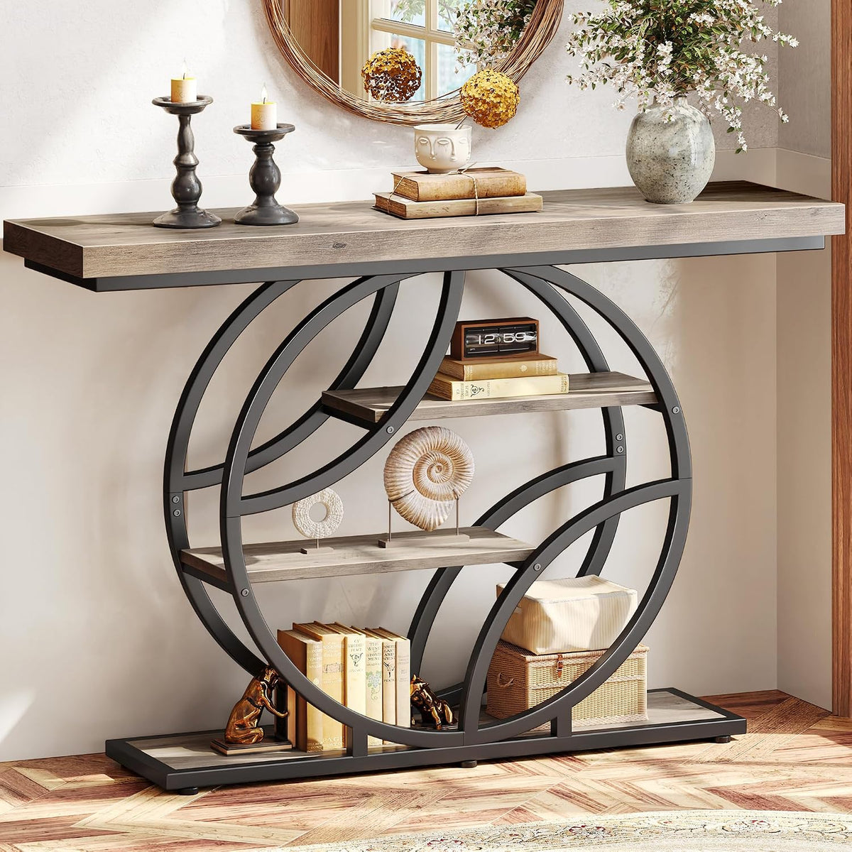 Right-side angled view of the console table in a lighter wood finish, styled with candles, vase, and stacked books.