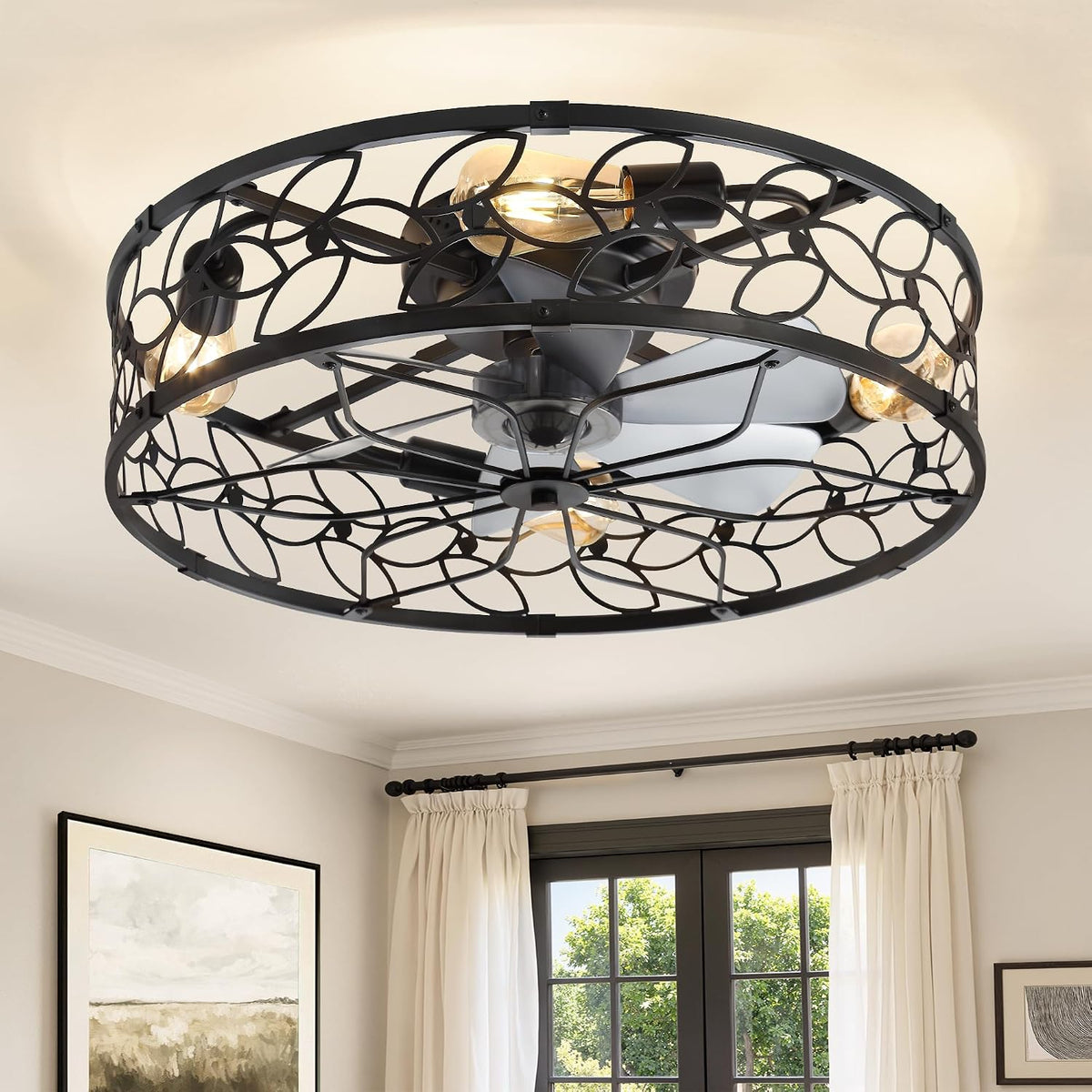Angled view of a black metal caged ceiling fan revealing fan blades and the openwork circular pattern.