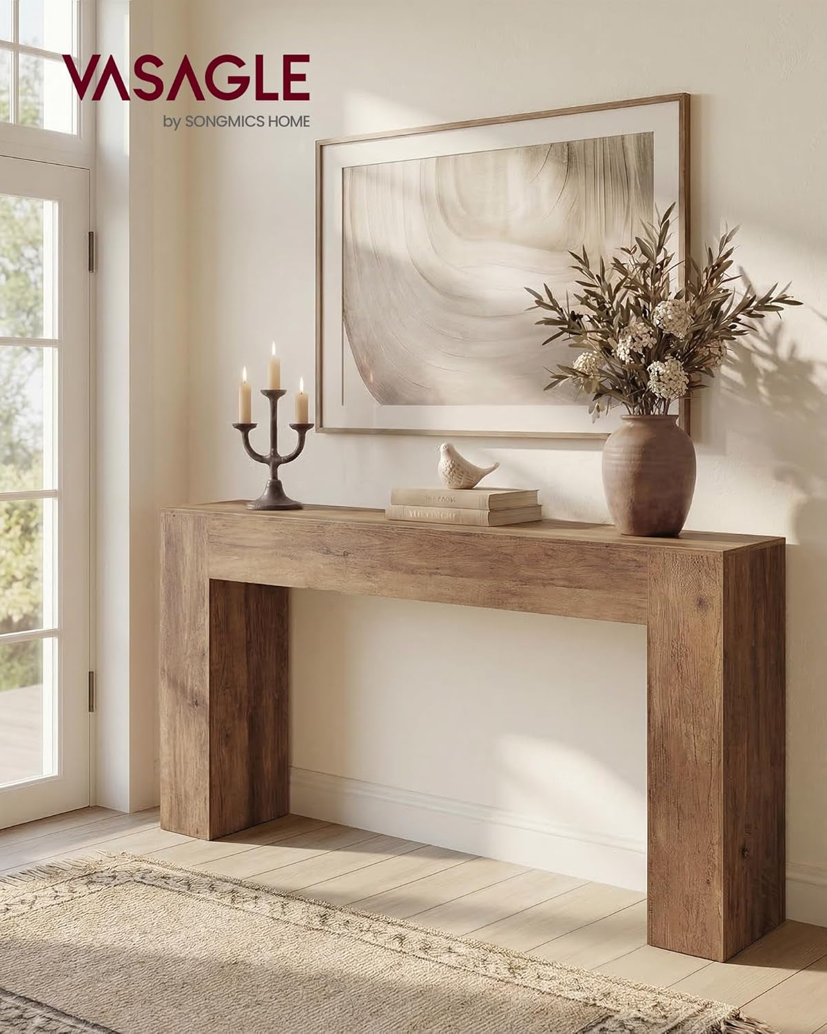Styled entryway scene showing the U-shaped console table under a framed artwork with decor and natural light