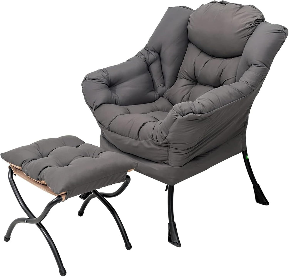 Dark grey padded lounge chair with matching tufted ottoman on white background