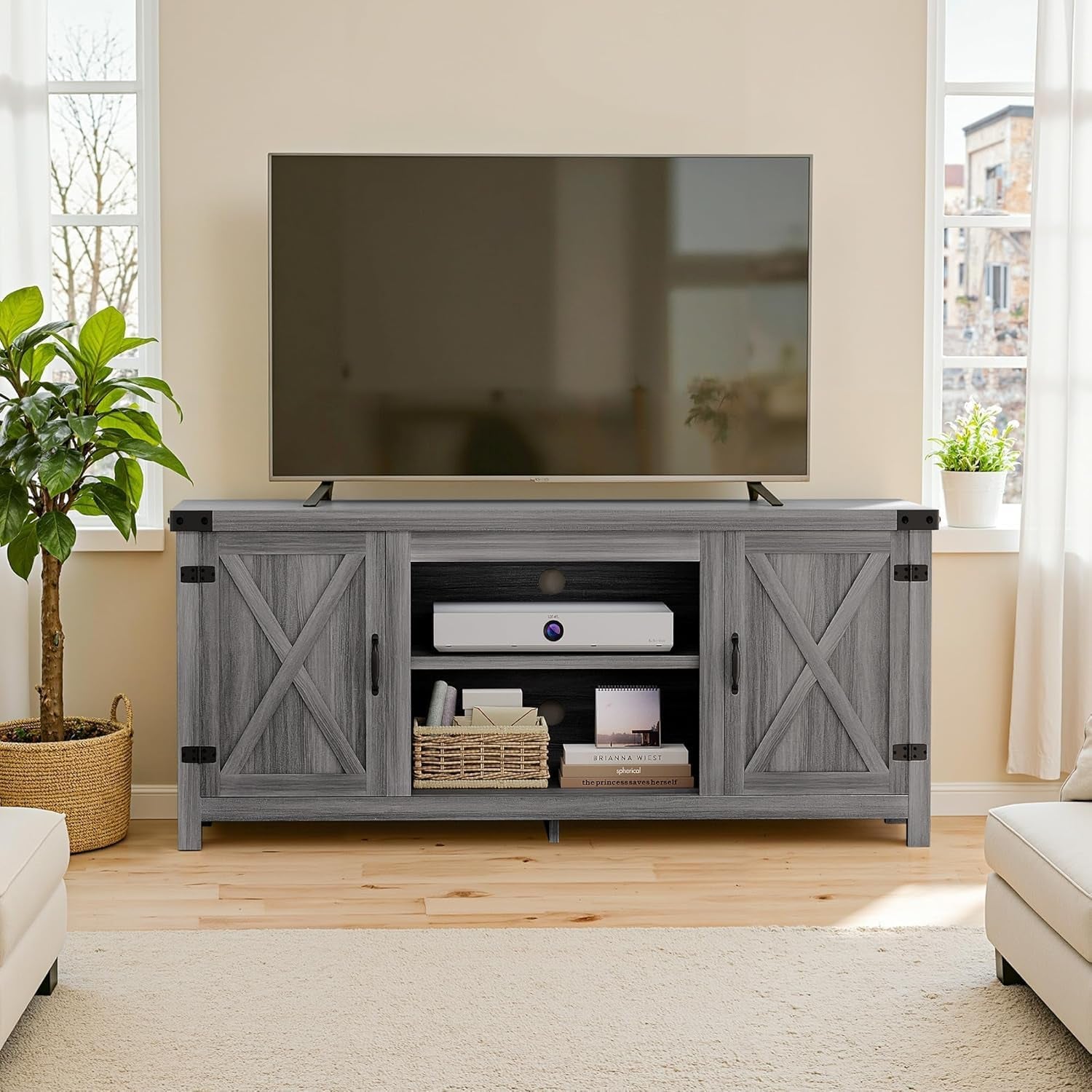 Gray farmhouse TV console with open center shelving, X-panel doors and a flat-screen TV on top.
