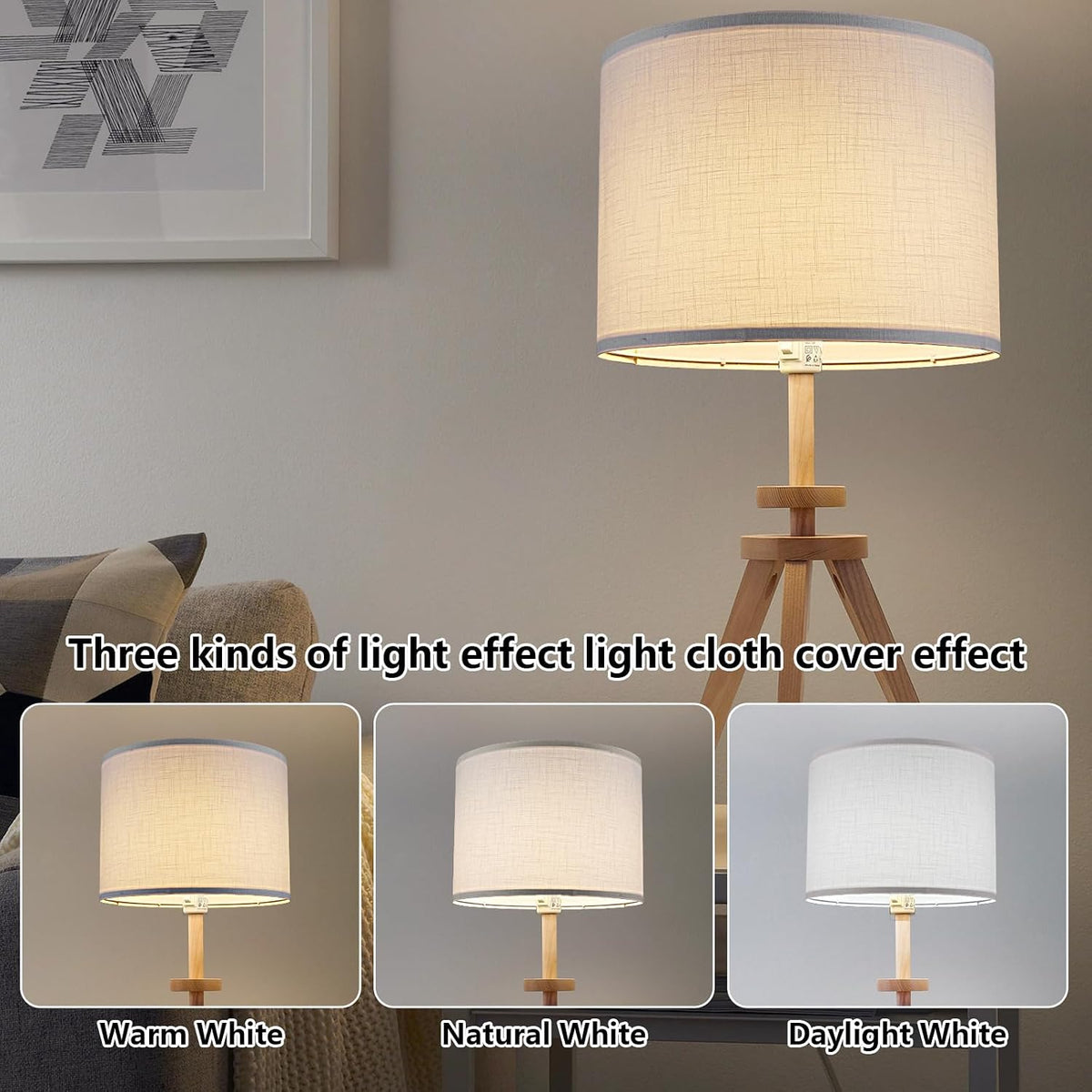 White drum lamp shade illuminated on a wooden tripod lamp showing warm ambient lighting