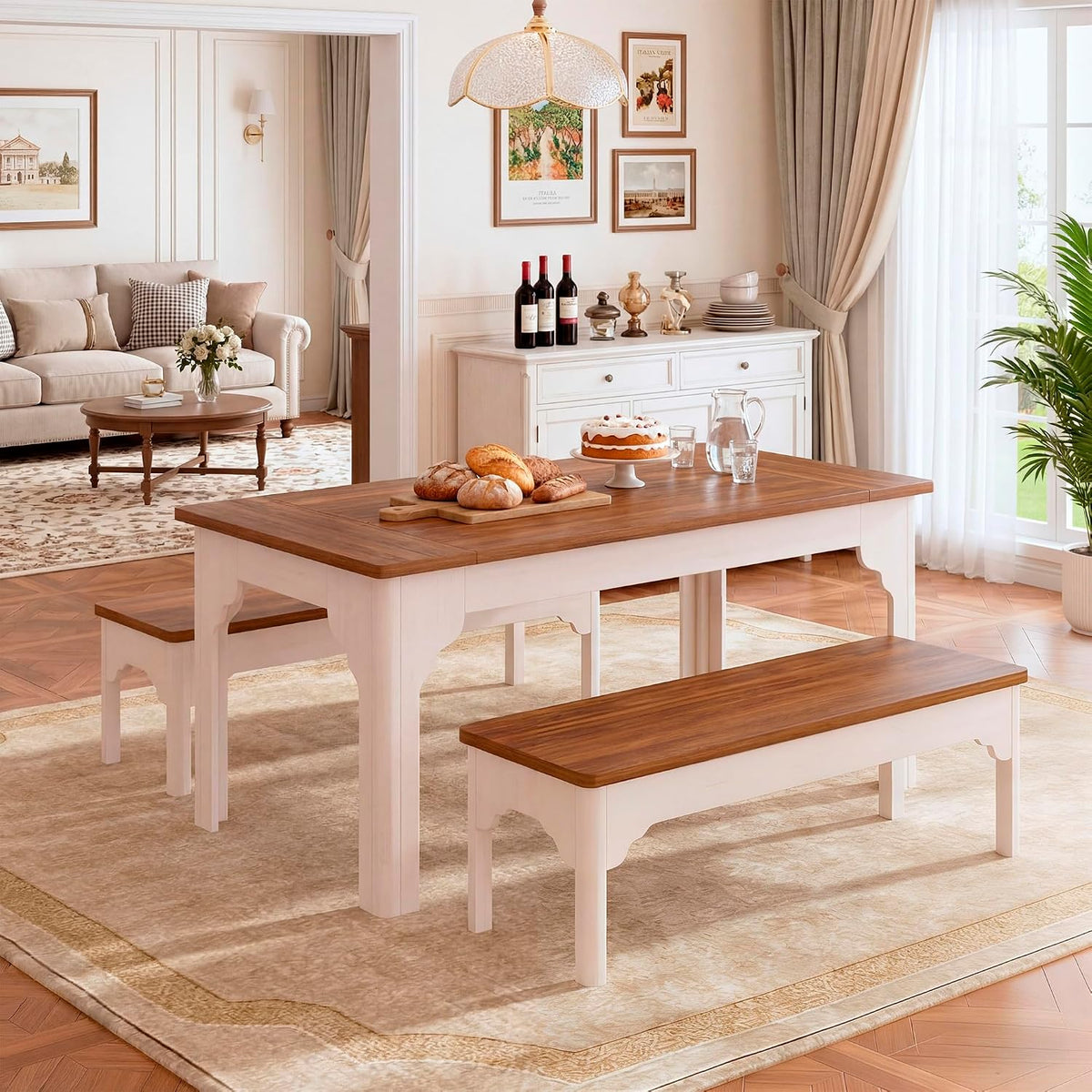 Three-quarter view of farmhouse table with brown top and white base, two benches, bread and cake on the tabletop and a