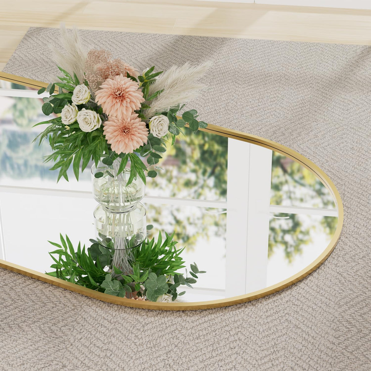 Low-angle close-up of the mirror edge reflecting a vase of flowers and a window on carpeted floor.