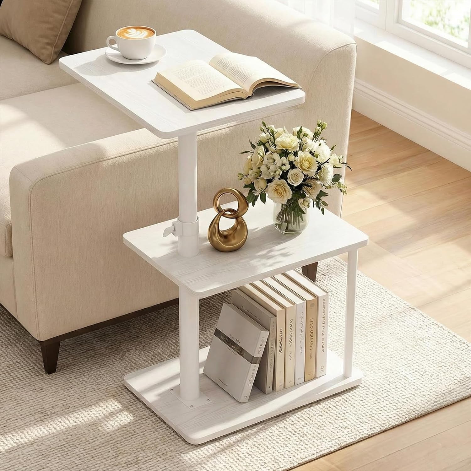 White C-shaped three-tier side table beside a beige sofa with books and flowers on shelves