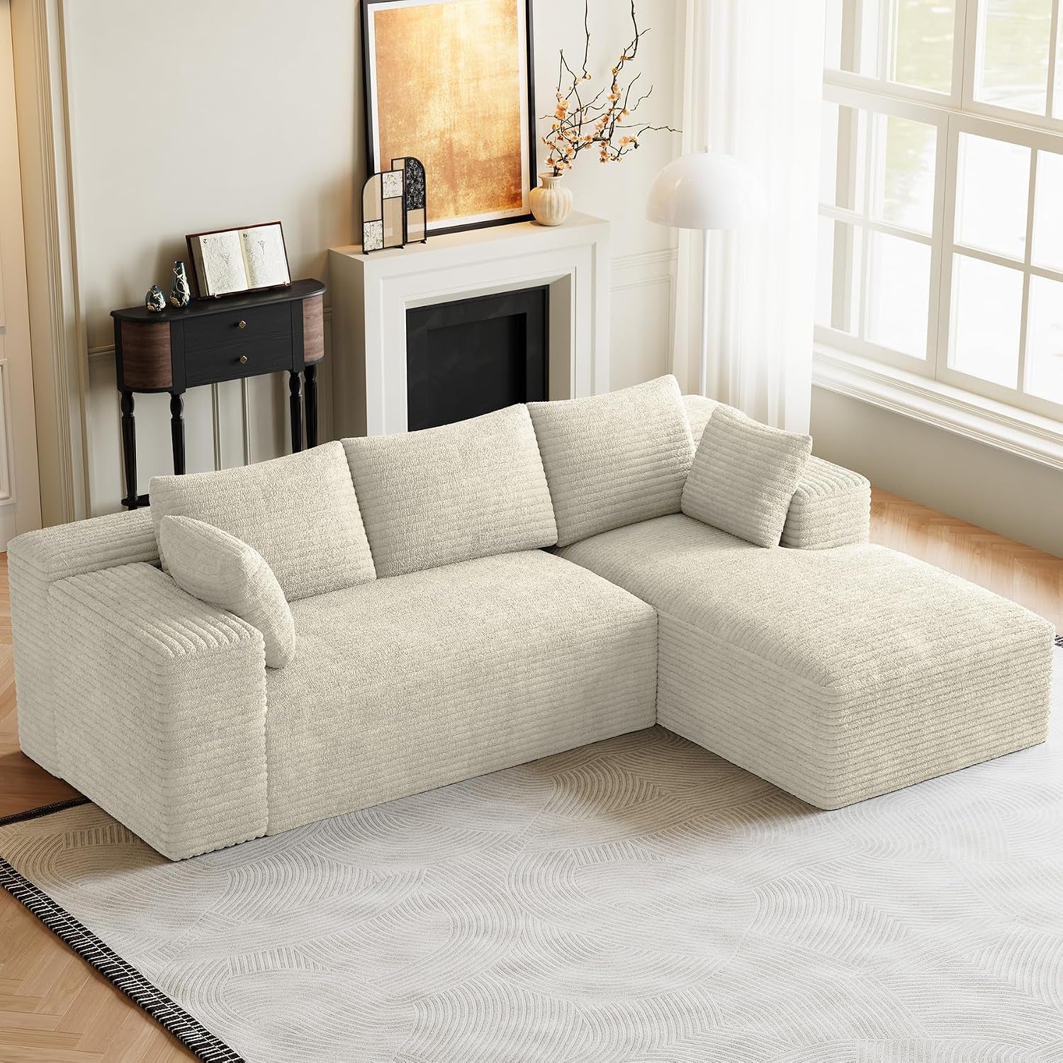 Cream L-shaped modular sectional with chaise in a sunlit room near a window