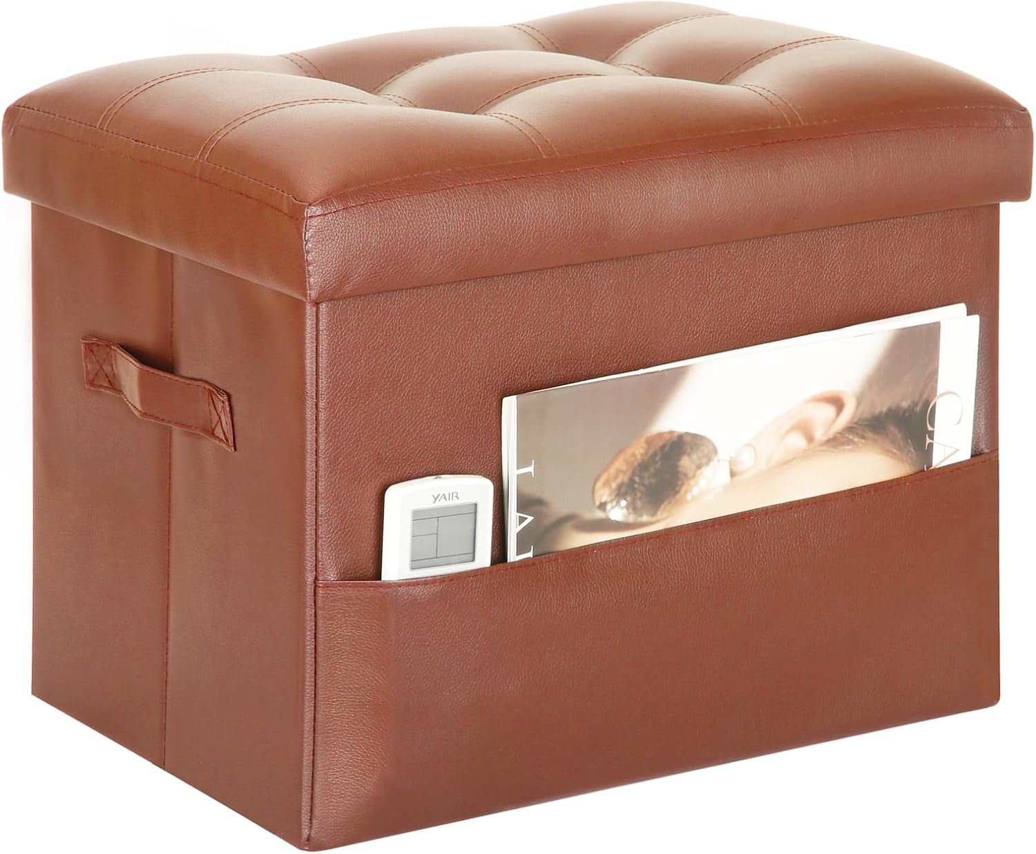Brown PU leather storage ottoman with tufted cushioned lid, side handle and pocket holding a remote and magazine