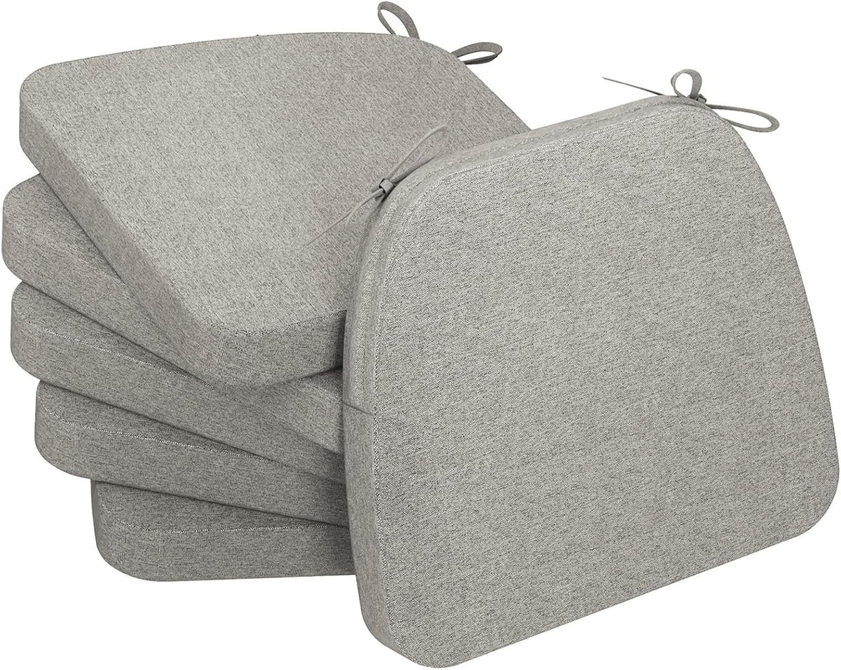 Stack of four D-shaped seat cushions in a light oatmeal beige fabric with tie loops visible