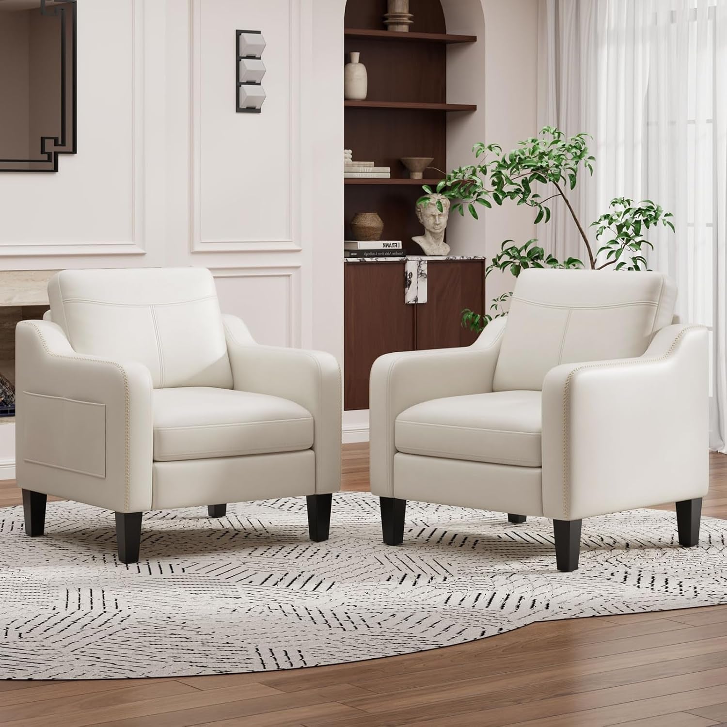 Pair of cream-white PU leather armchairs arranged side by side on a patterned rug.