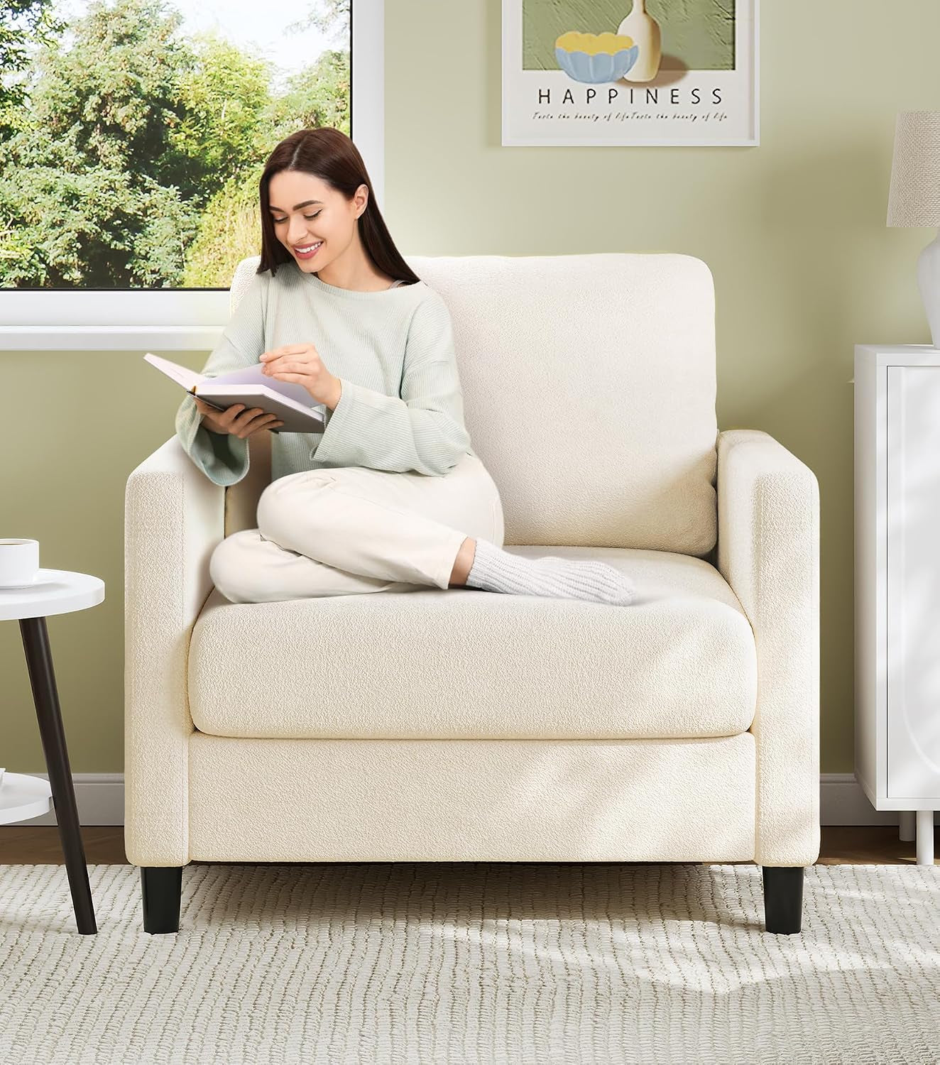 Woman reading on a cream-colored teddy-fabric armchair in a sunny room