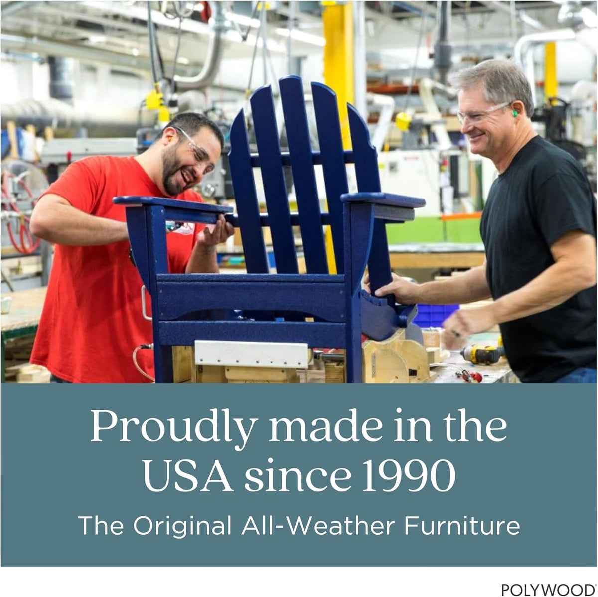 Two factory workers assembling a navy Adirondack chair on a workbench in a workshop setting