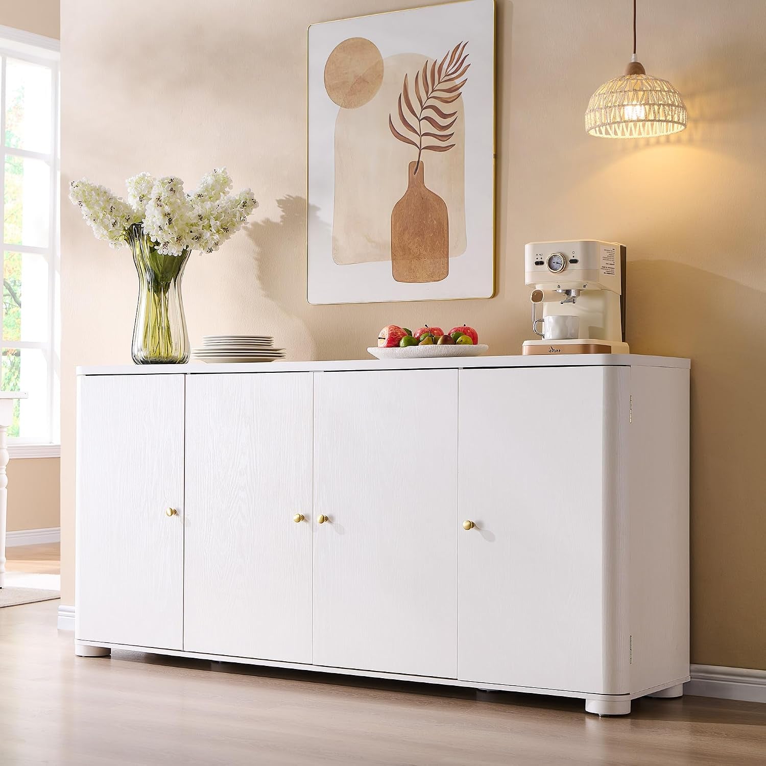 White-finish four-door sideboard in a living room setting with a vase of flowers and a coffee machine on top.