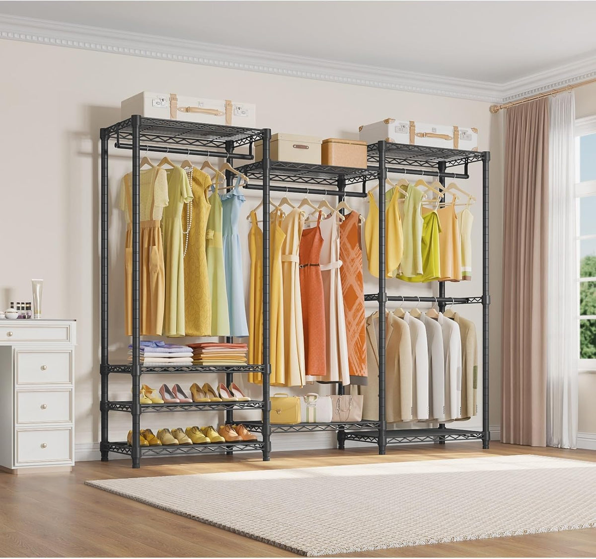 Three-section black closet system arranged in a bright bedroom, holding dresses, suits, folded clothes and shoes