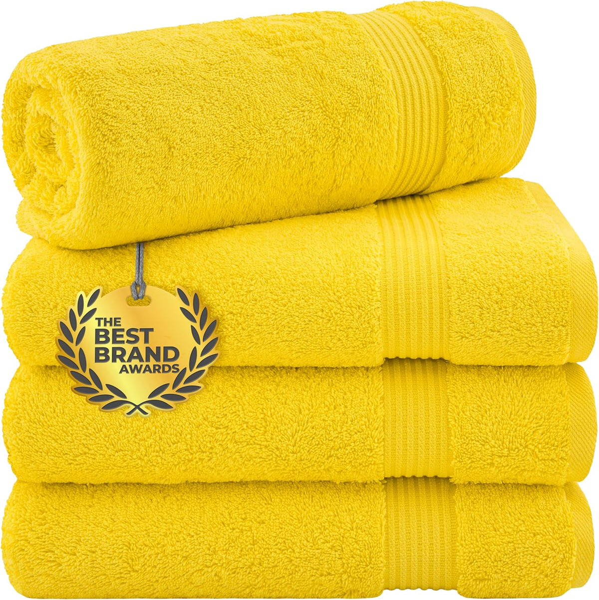 Stack of three bright yellow towels with one rolled on top and a gold award medallion tag hanging