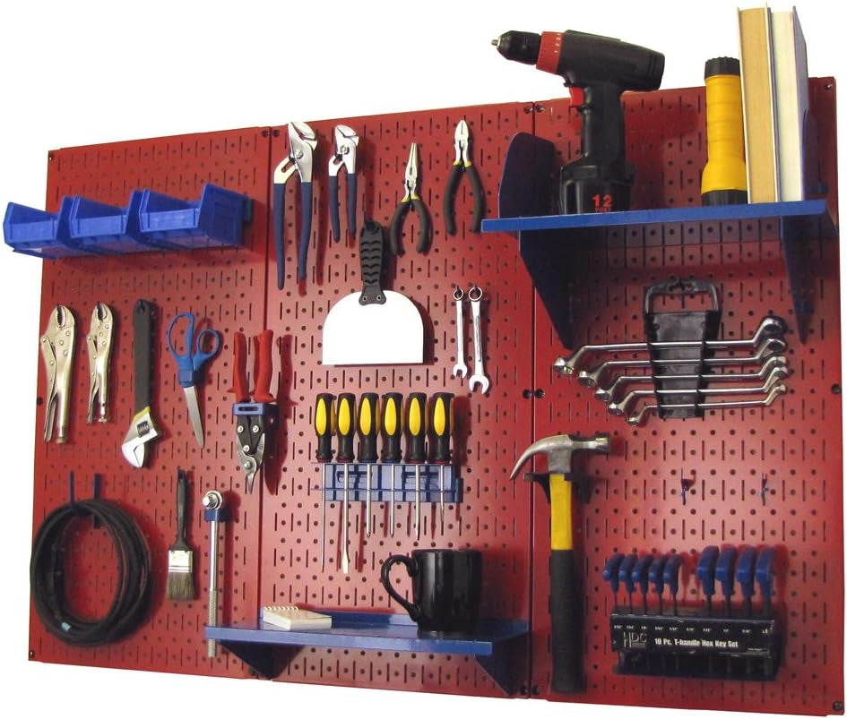 Red metal pegboard mounted on wall with hooks, shelves and assorted hand tools organized across the surface.