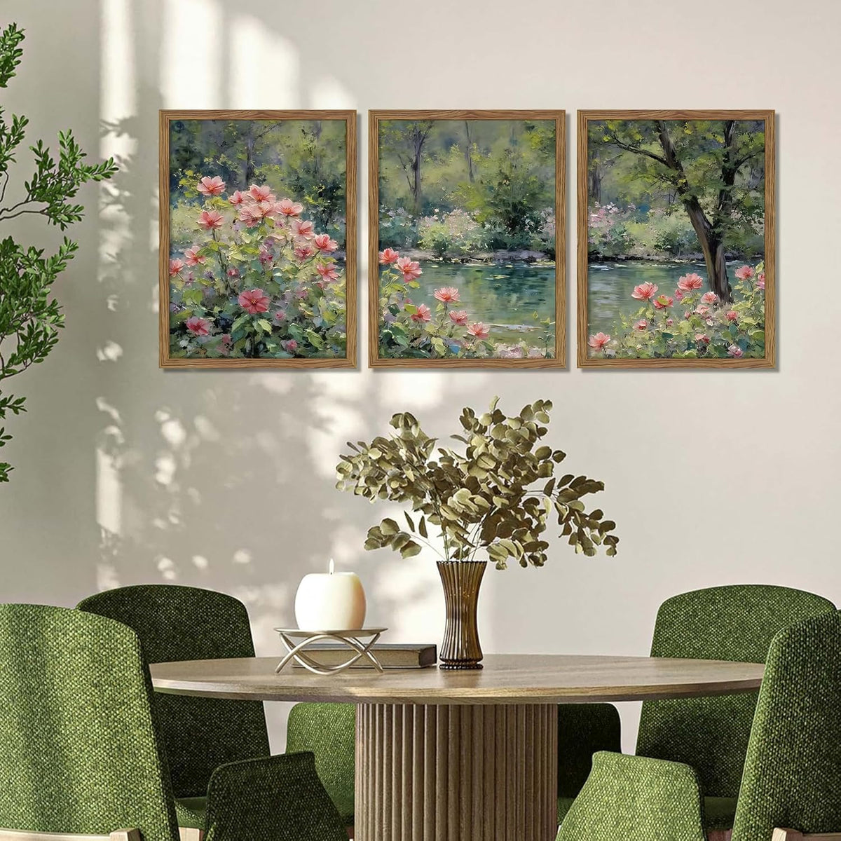 Three wood-framed floral canvases displayed above a dining table with green upholstered chairs.