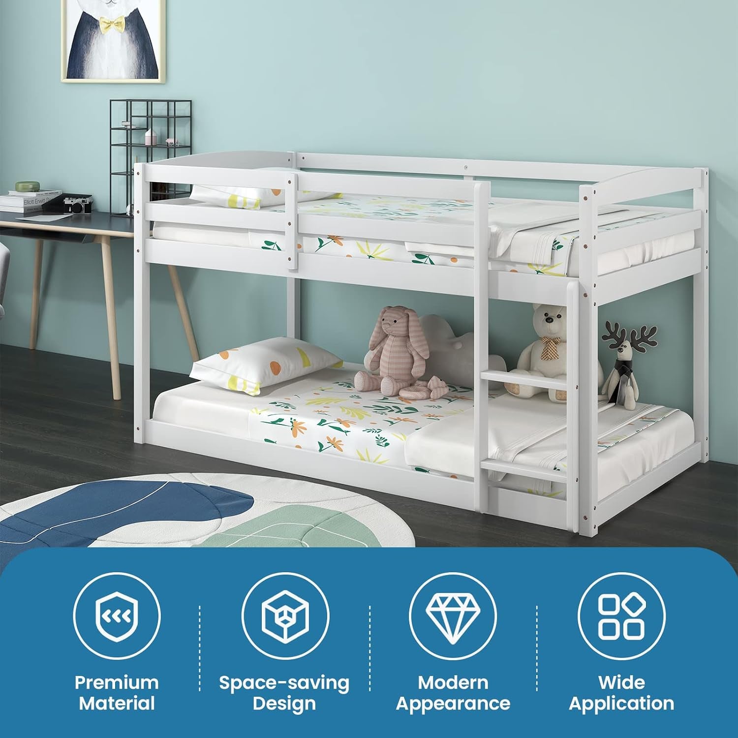 White low twin-over-twin bunk bed in a styled kids room with teal wall, toys and desk nearby.