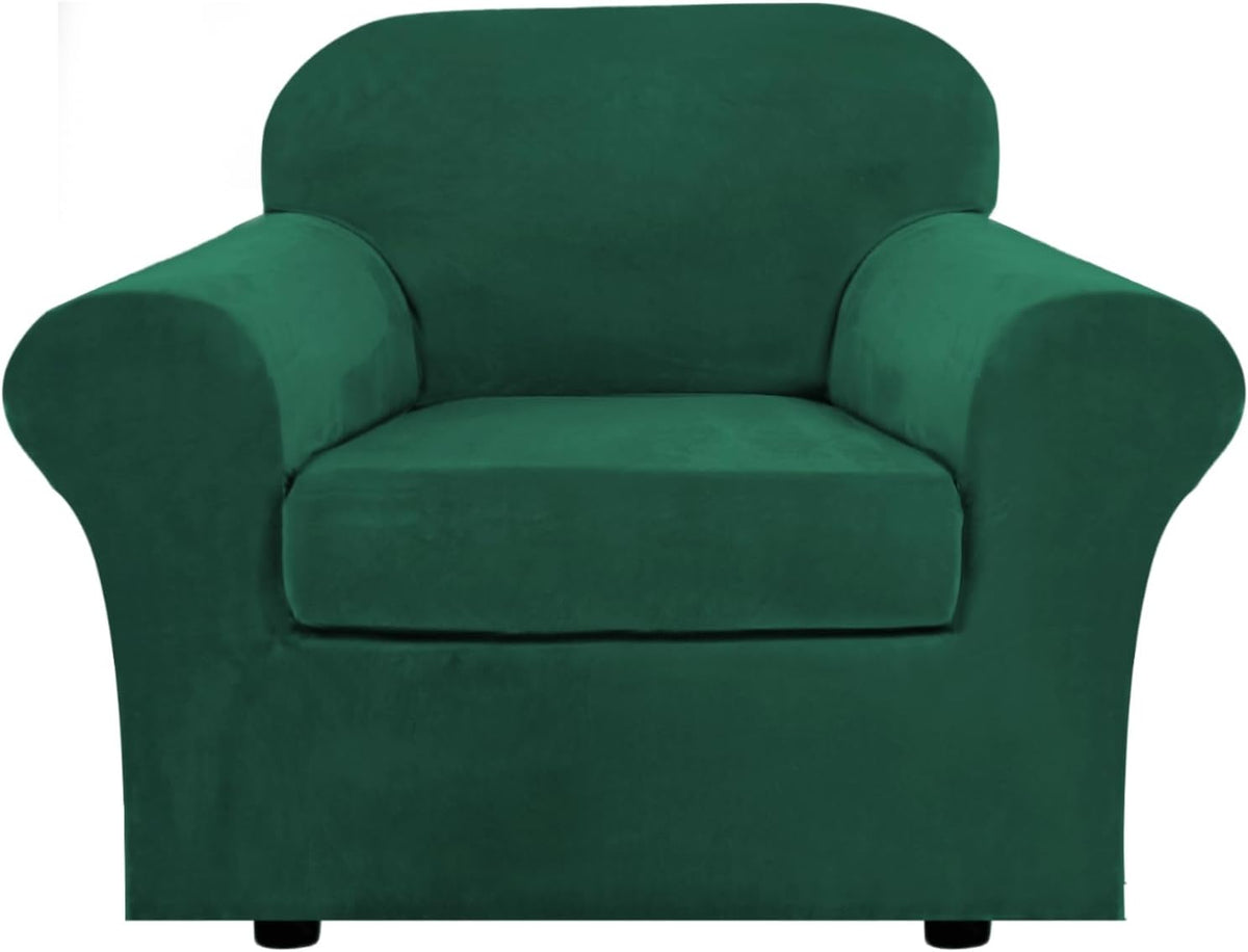 Close front view of a single armchair covered in deep emerald green stretch velvet fabric.
