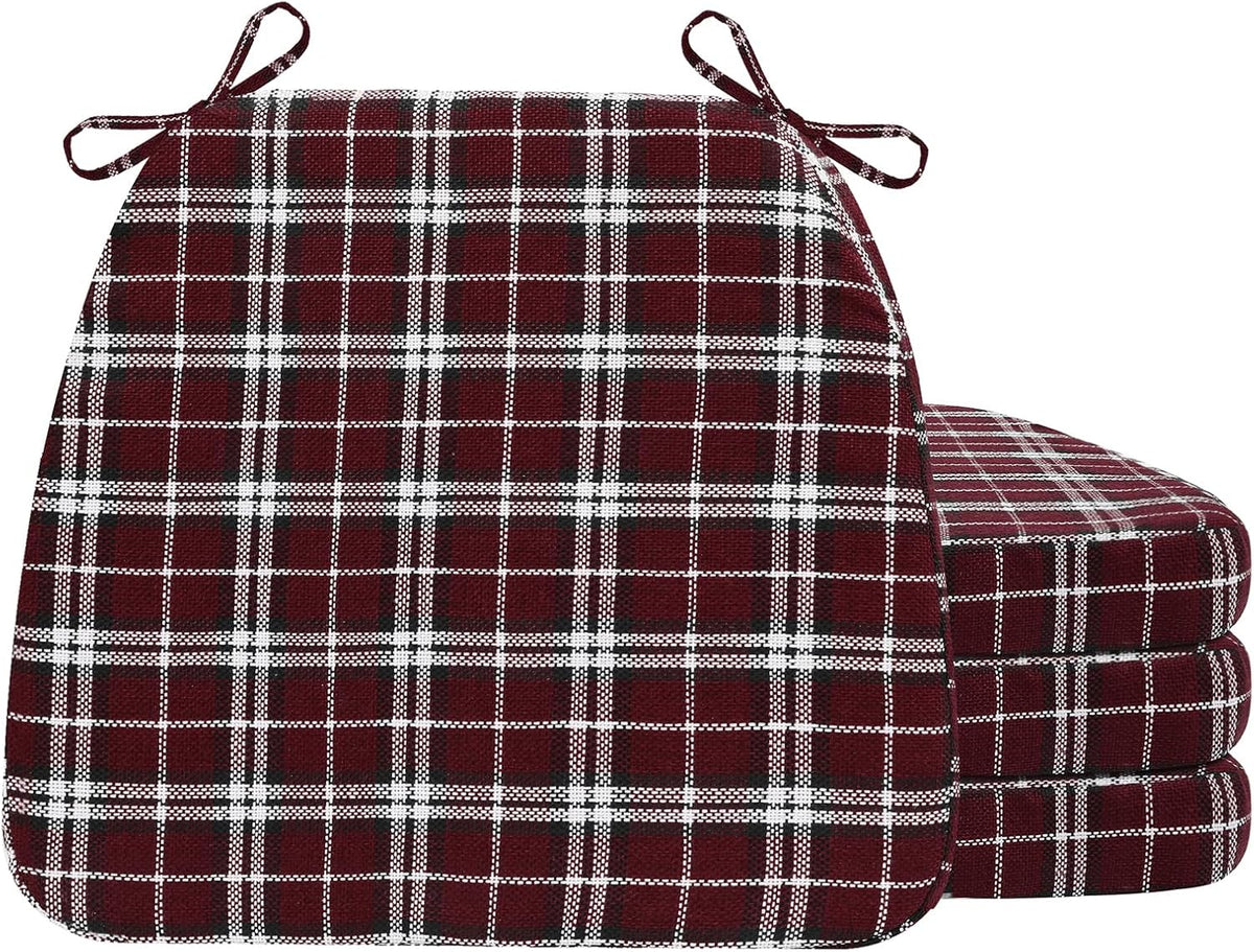 Front view of burgundy plaid D-shaped cushions, one standing with three stacked to the right, bold check pattern visible.
