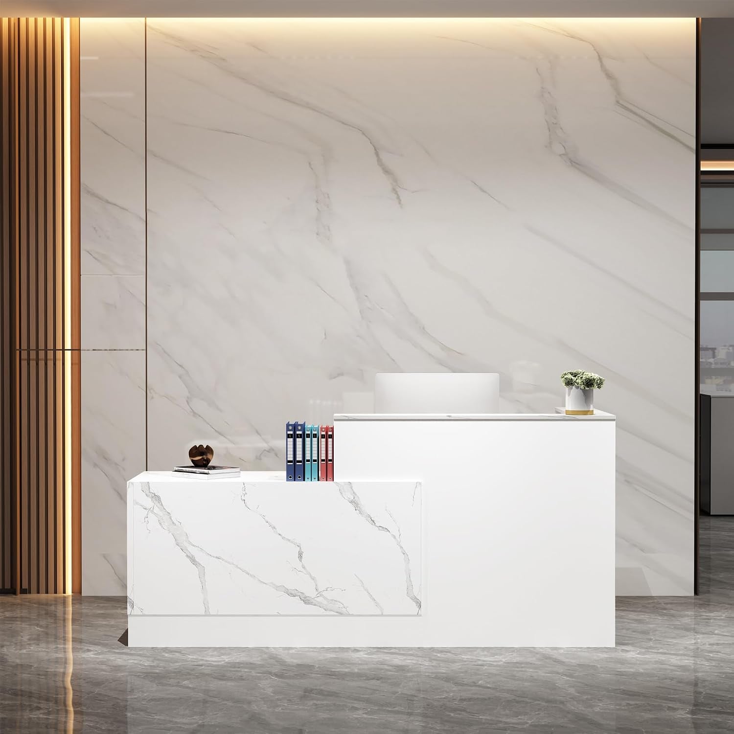 White L-shaped reception desk with marble-pattern front panel, stack of folders, small plant, and marble wall background