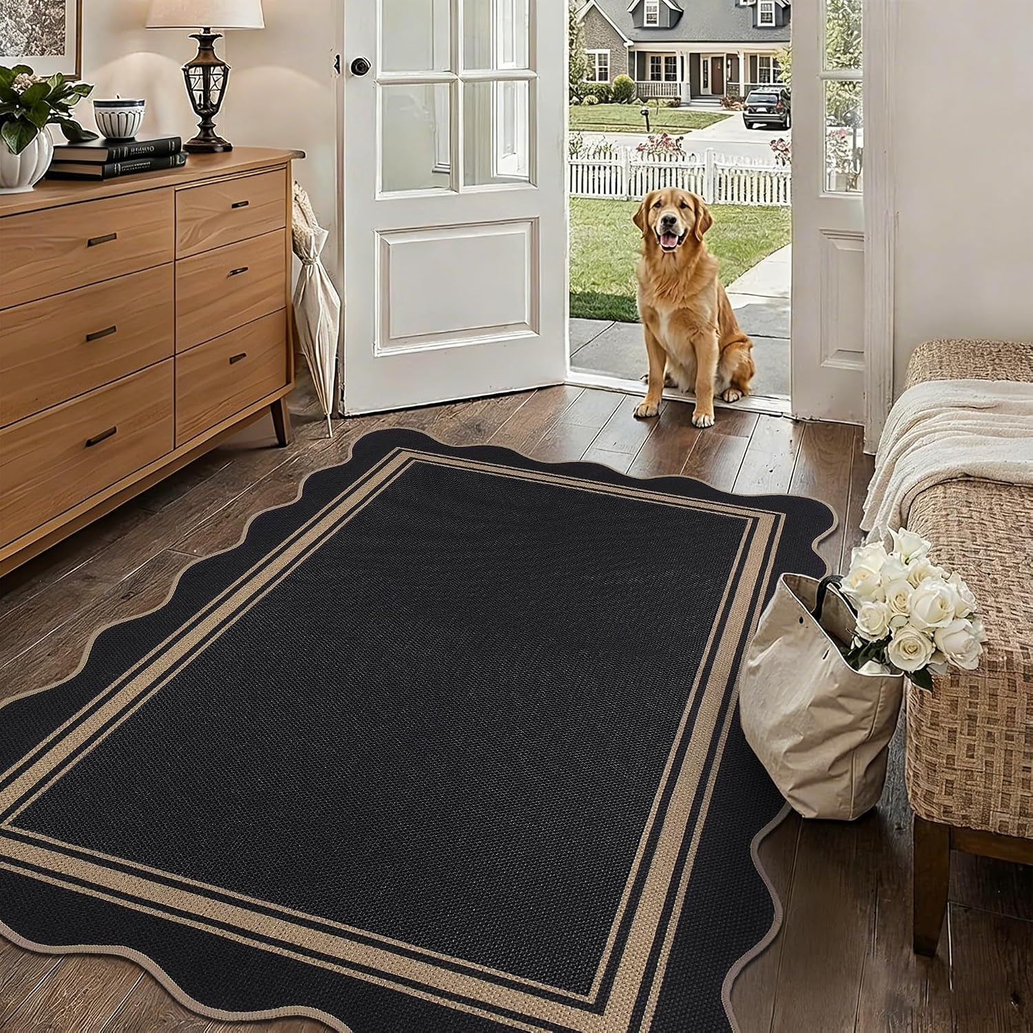 Close entry view of a black scalloped rug beside a bench and bag of white roses