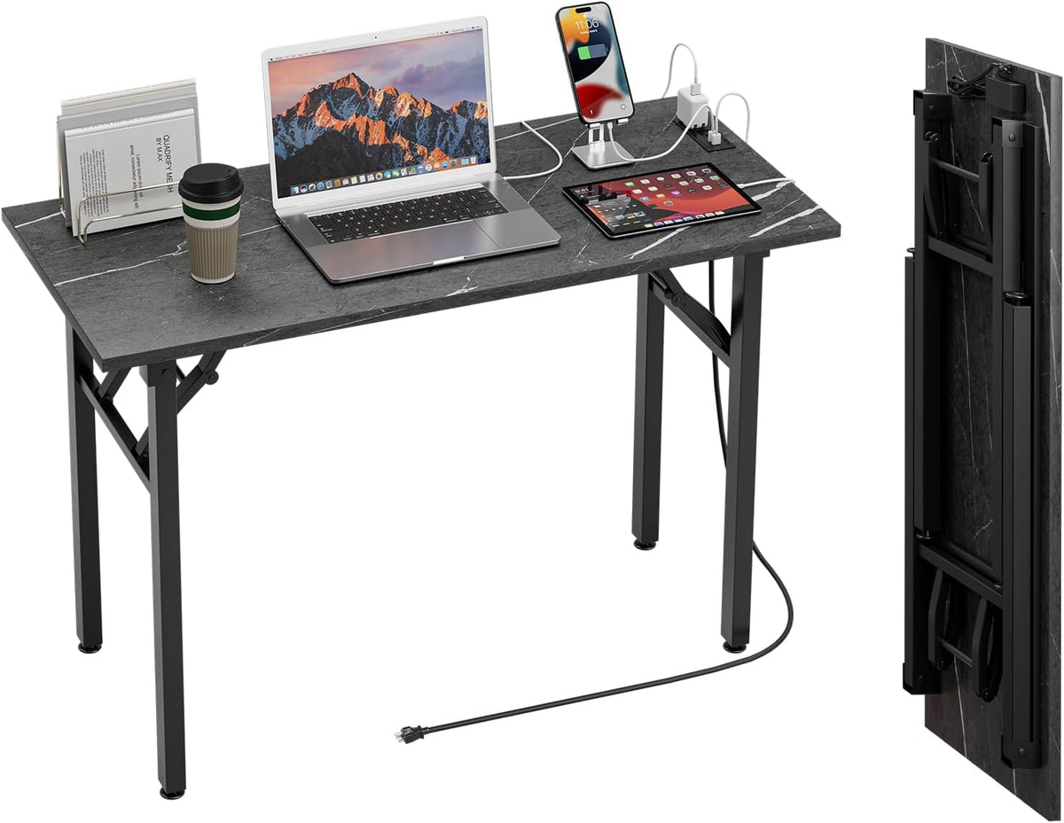 Black marble‑finish folding desk set up with laptop, tablet and charging cables; inset shows the tabletop folded upright.