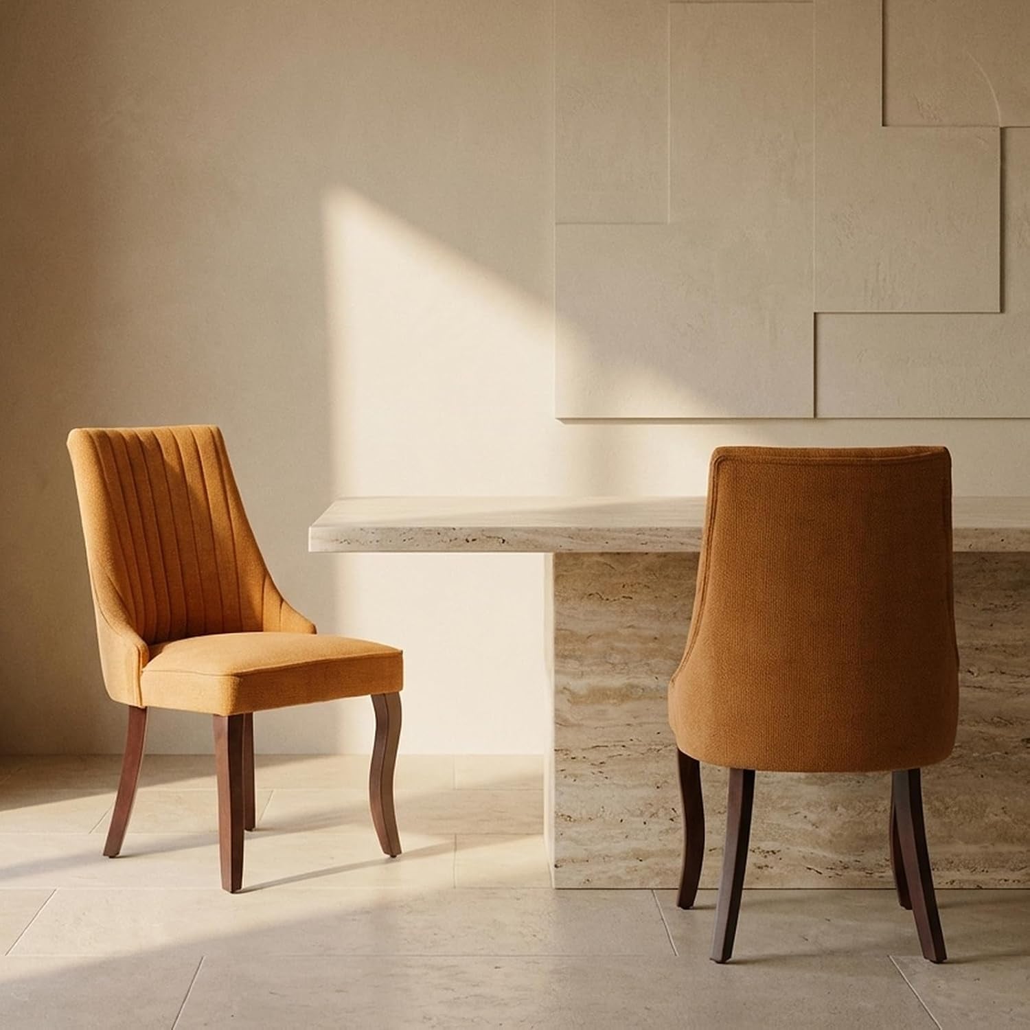 Two mustard-colored upholstered high-back chairs shown from side and rear beside a stone dining table
