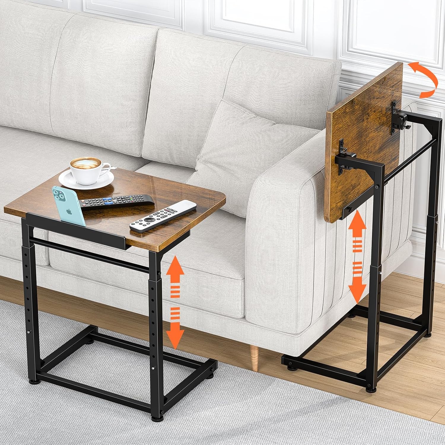 Brown wood-top C-shaped side table by a light gray sofa holding a cup, remotes and phone in slot.