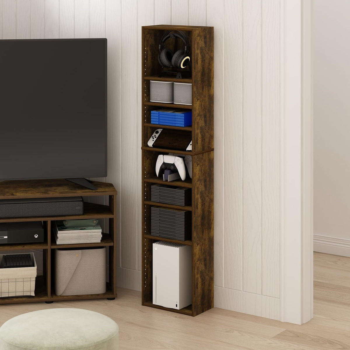 Amber Pine finish media tower staged next to a TV, filled with game consoles and cases in a living room scene