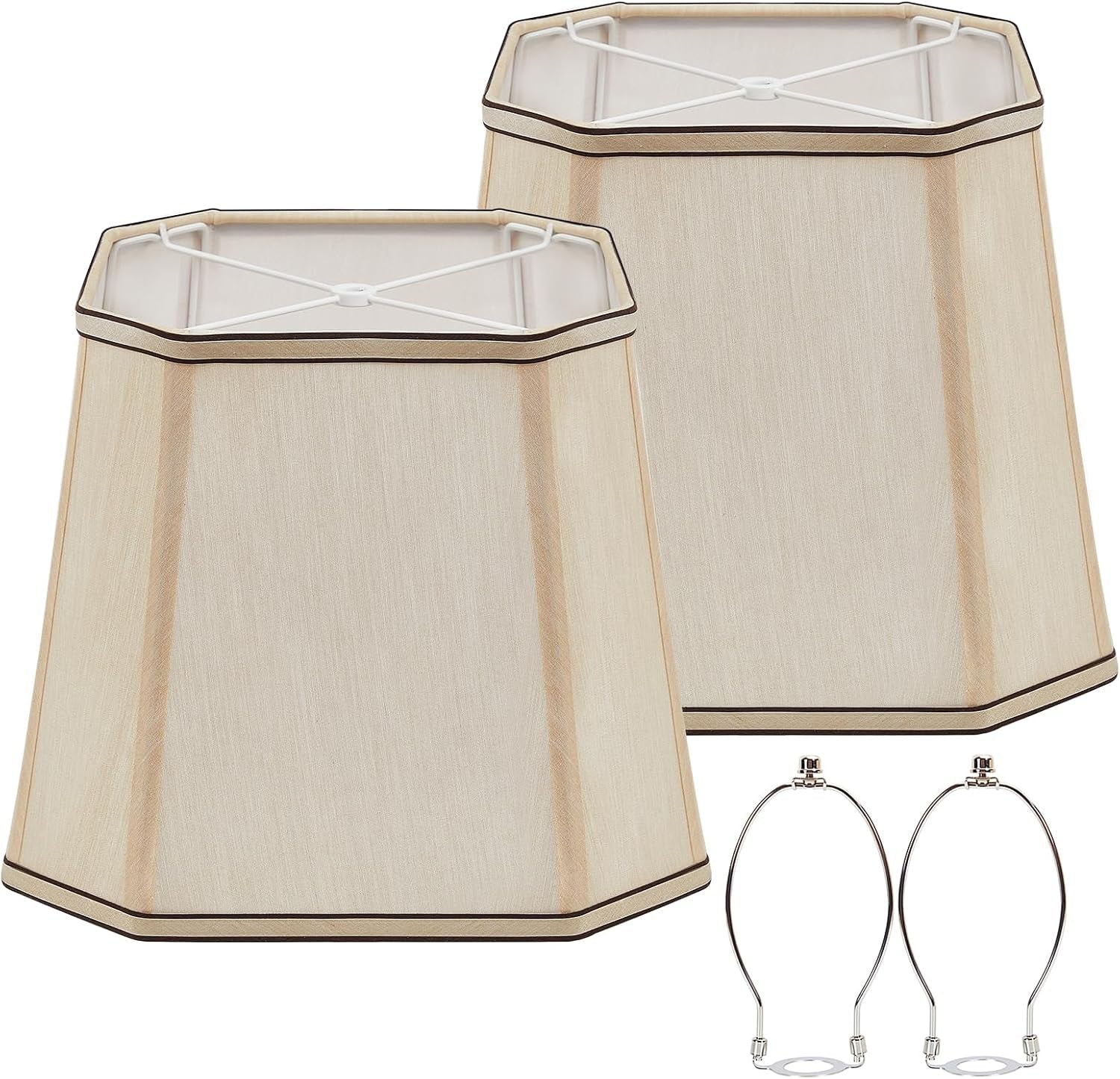 Two beige hexagonal lampshades angled to show the inner spider frames with two silver harp fittings.