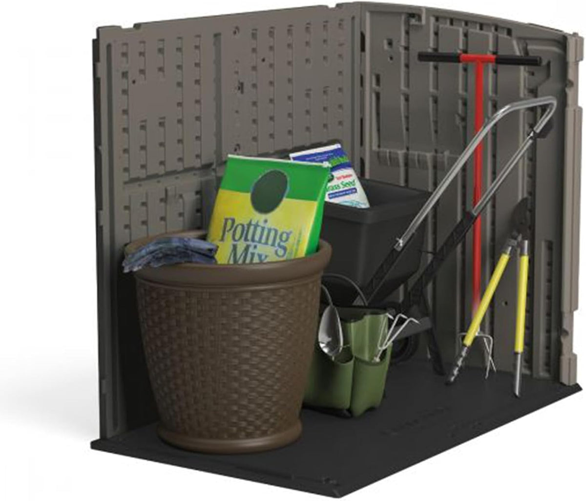 Close interior shot showing gardening tools, a pot, potting mix bag and small tools leaned against molded resin walls.