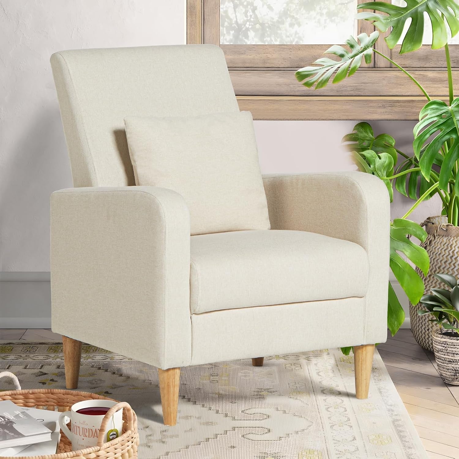 Cream high-back accent chair with removable pillow and wood legs in a bright room by a window.
