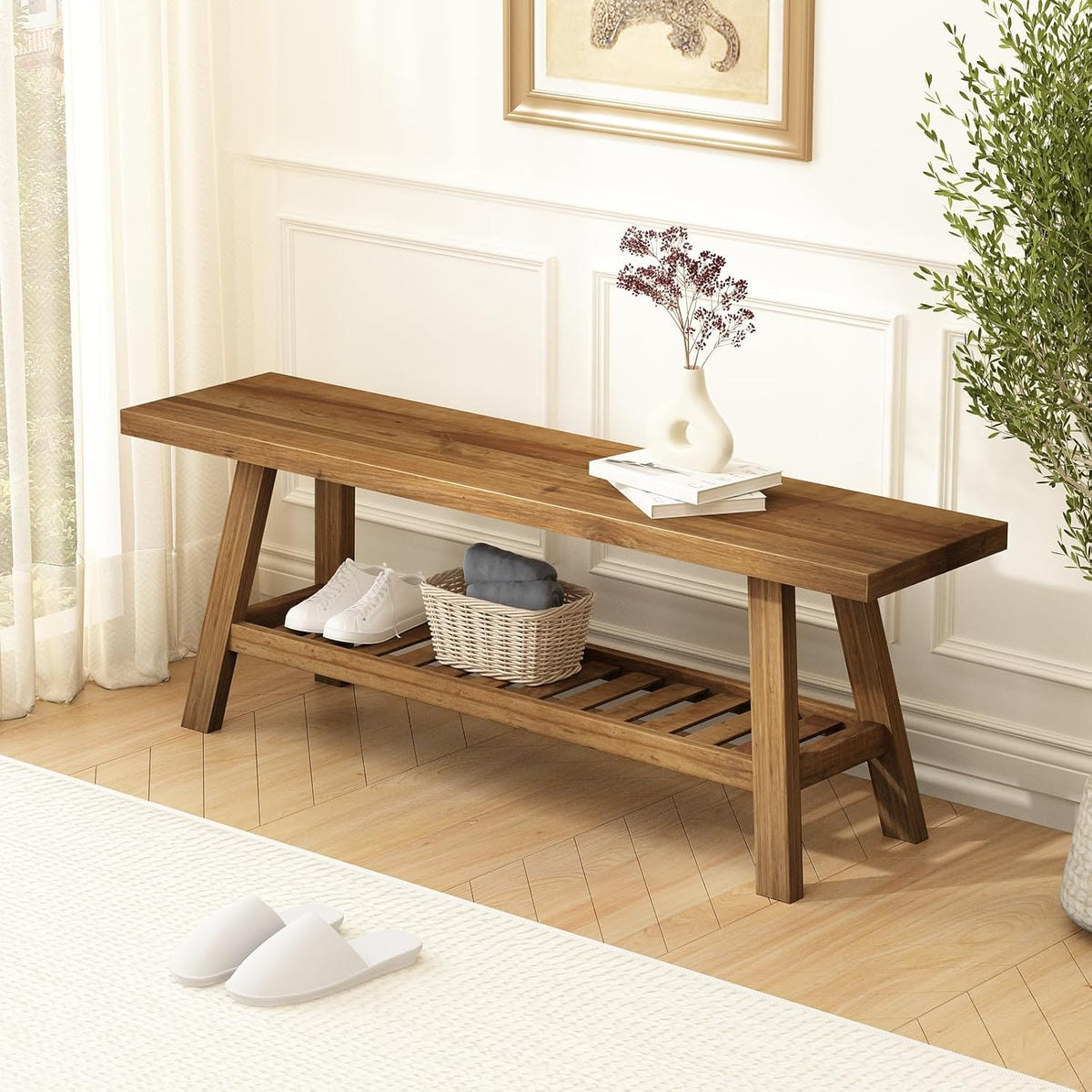 Solid wood bench front view in an entryway with shoes and a wicker basket on the lower shelf