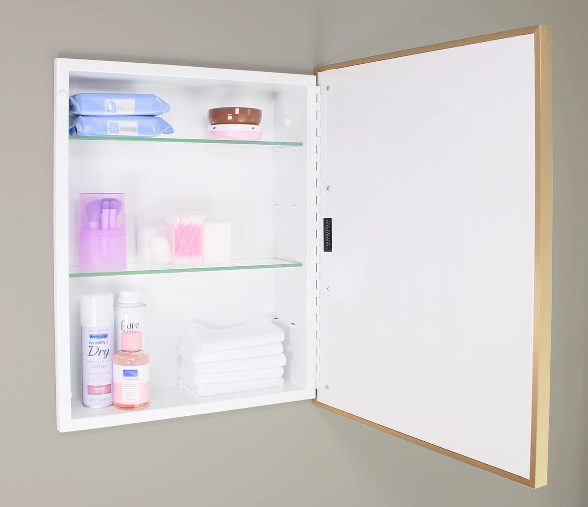 Recessed medicine cabinet interior with mirror door open showing two adjustable tempered glass shelves and white cabinet back