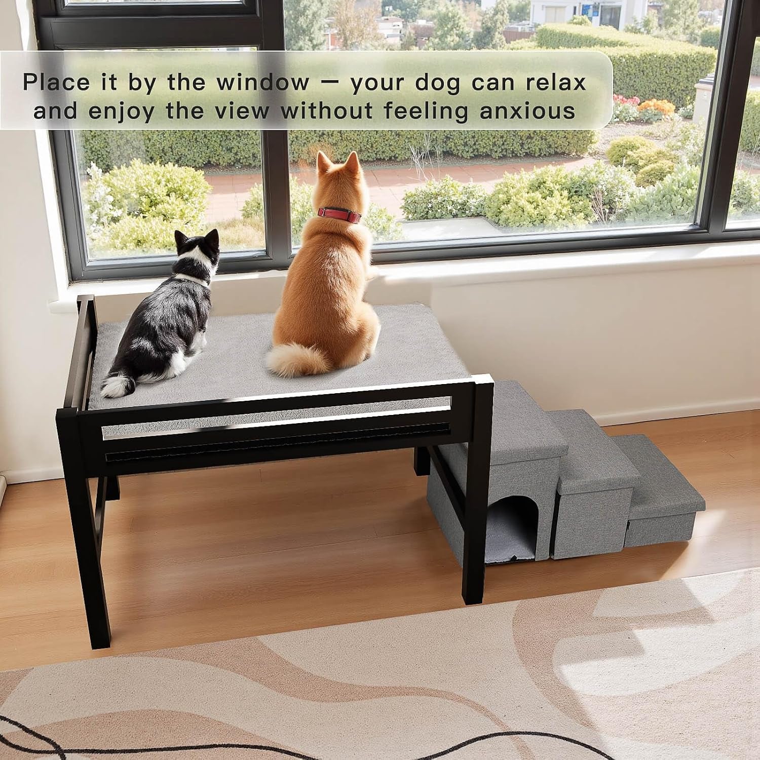 Black bedside co-sleeper with gray mattress by a window with two cats sitting on the mattress and gray foldable stairs with-c